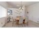 Neutral dining room with chandelier and a light wood table set at 12935 Lake Circle Dr, Thornton, CO 80241