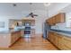 Modern kitchen features hardwood floors, light wood cabinets, and stainless steel appliances at 12935 Lake Circle Dr, Thornton, CO 80241