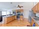 Bright kitchen featuring stainless steel appliances and light wood cabinetry at 12935 Lake Circle Dr, Thornton, CO 80241