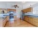 Beautiful kitchen with hardwood floors, light wood cabinets, and stainless steel appliances at 12935 Lake Circle Dr, Thornton, CO 80241