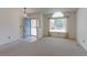 Inviting living room with a blue front door, neutral carpet, and a large window at 12935 Lake Circle Dr, Thornton, CO 80241