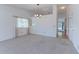 Spacious living room with neutral carpet, large window, and access to the hallway at 12935 Lake Circle Dr, Thornton, CO 80241