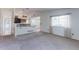 Open-concept living area with a view to the kitchen, offering an airy and inviting atmosphere at 12935 Lake Circle Dr, Thornton, CO 80241