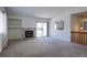 Inviting living room with a cozy fireplace and sliding glass door to backyard at 12935 Lake Circle Dr, Thornton, CO 80241
