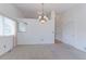 Bright living room features neutral carpet, a chandelier, and a view of the backyard at 12935 Lake Circle Dr, Thornton, CO 80241