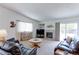 Cozy living room featuring a fireplace, comfortable seating, and a sliding glass door to the yard at 12935 Lake Circle Dr, Thornton, CO 80241