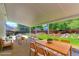 Covered patio with comfortable seating, a dining table, and views of the backyard at 12935 Lake Circle Dr, Thornton, CO 80241