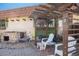 This backyard offers a stone grill, pergola, and a seating area, ideal for relaxation and outdoor enjoyment at 1490 S Salem Way, Aurora, CO 80012