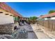 Landscaped backyard with a brick patio, built-in stone grill, pergola, and mature trees offers a private retreat at 1490 S Salem Way, Aurora, CO 80012