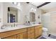 Bright bathroom with dual sinks, wood cabinets and glass-enclosed shower at 1490 S Salem Way, Aurora, CO 80012
