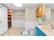 Bathroom with blue vanity, shower with glass door, and a patterned tile floor at 1490 S Salem Way, Aurora, CO 80012