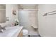 Bathroom featuring a glass-enclosed shower with built-in seat and updated fixtures at 1490 S Salem Way, Aurora, CO 80012