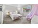 Bright bedroom featuring plush carpet, a large window and designer accents at 1490 S Salem Way, Aurora, CO 80012