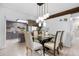 Elegant dining area featuring stylish lighting, a modern glass table, and comfortable seating for memorable meals at 1490 S Salem Way, Aurora, CO 80012