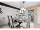 Bright dining room showcasing a glass table, elegant chairs, and sliding door access to the outdoor living area at 1490 S Salem Way, Aurora, CO 80012