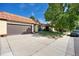 Charming home featuring a tile roof, a large front yard tree, and an attached two-car garage at 1490 S Salem Way, Aurora, CO 80012
