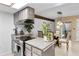 Well-equipped kitchen opening up to a dining area, featuring modern appliances and stylish finishes for cooking and dining at 1490 S Salem Way, Aurora, CO 80012