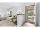 Bright living room featuring fresh white walls, modern decor, and a cozy seating arrangement by the door at 1490 S Salem Way, Aurora, CO 80012