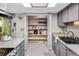 Walk in pantry with abundant storage and lighting, with granite countertops in view at 1490 S Salem Way, Aurora, CO 80012
