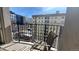 Relaxing city view from a balcony with wrought iron railing, chair, and cityscape backdrop at 475 W 12Th Ave # 8H, Denver, CO 80204