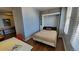 Cozy bedroom featuring a built-in Murphy bed, hardwood floors, and natural light from large windows at 475 W 12Th Ave # 8H, Denver, CO 80204