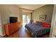 Bright bedroom with wood flooring, dresser, balcony, and large windows showcasing an amazing view at 475 W 12Th Ave # 8H, Denver, CO 80204
