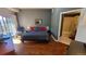 Cozy bedroom featuring wood floors, a modern bed, and an ensuite bathroom access at 475 W 12Th Ave # 8H, Denver, CO 80204