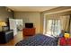 Primary bedroom with balcony access, dresser, and a large comfortable bed at 475 W 12Th Ave # 8H, Denver, CO 80204