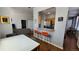 Open living space featuring modern decor, hardwood floors, and breakfast bar with seating at 475 W 12Th Ave # 8H, Denver, CO 80204