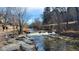 Scenic shot of the Cherry Creek river with walking trail on a sunny day at 475 W 12Th Ave # 8H, Denver, CO 80204