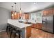 Open kitchen with stainless steel appliances, white subway tile backsplash, and a breakfast bar with seating at 1558 Castle Creek Cir, Castle Rock, CO 80104