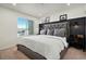 A primary bedroom featuring a large upholstered headboard and modern wall sconces at 1558 Castle Creek Cir, Castle Rock, CO 80104