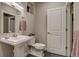 Bright bathroom featuring a pedestal sink, tile flooring, and modern fixtures at 5185 Vivian St, Wheat Ridge, CO 80033
