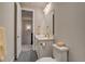 This bathroom features tile flooring, a vanity, and a mirror at 5185 Vivian St, Wheat Ridge, CO 80033