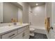 This bathroom features a shower-tub combo, vanity, and neutral wall color at 5185 Vivian St, Wheat Ridge, CO 80033