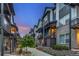 Contemporary townhomes with private balconies, walkways, and lush landscaping along the street at 5185 Vivian St, Wheat Ridge, CO 80033