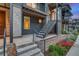 Modern townhome with a private entrance, sleek metal railings, and tasteful landscaping at 5185 Vivian St, Wheat Ridge, CO 80033