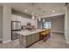 Bright kitchen with island, pendant lighting, stainless steel appliances and ample counter space at 5185 Vivian St, Wheat Ridge, CO 80033