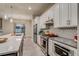 Modern kitchen with white cabinets, stainless steel appliances, and a stylish backsplash at 5185 Vivian St, Wheat Ridge, CO 80033