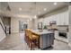 Spacious kitchen featuring a large island with seating and open layout to the living area at 5185 Vivian St, Wheat Ridge, CO 80033