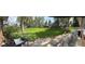 Panoramic view of a large, well-manicured lawn with established trees and patio seating at 10366 E Ida Ave, Greenwood Village, CO 80111