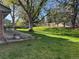 Expansive backyard with lush lawn, mature trees providing shade, and a patio area at 10366 E Ida Ave, Greenwood Village, CO 80111