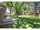 Lush backyard features a concrete patio area and mature trees creating a serene outdoor space at 10366 E Ida Ave, Greenwood Village, CO 80111