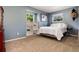 Calm blue bedroom with white bedding, built-in shelves, and dual windows with natural light at 10366 E Ida Ave, Greenwood Village, CO 80111