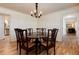 Formal dining room with hardwood floors, elegant chandelier, and classic furnishings at 10366 E Ida Ave, Greenwood Village, CO 80111