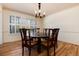 Elegant dining room with hardwood floors, natural light, and classic chandelier at 10366 E Ida Ave, Greenwood Village, CO 80111