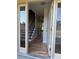 Welcoming entryway with hardwood floors, staircase and bright natural light at 10366 E Ida Ave, Greenwood Village, CO 80111