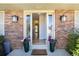 Inviting entryway with brick detail, decorative plants, and view to a bright foyer at 10366 E Ida Ave, Greenwood Village, CO 80111