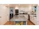 Bright kitchen featuring an island, granite countertops, white cabinetry, and stainless steel appliances at 10366 E Ida Ave, Greenwood Village, CO 80111