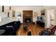 Comfortable living room with brick fireplace, wood-paneled walls, and classic furniture under vaulted ceilings at 10366 E Ida Ave, Greenwood Village, CO 80111
